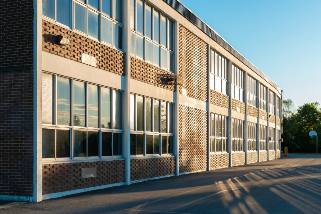 School building and schoolyard in the evening